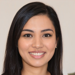 Joyful latino young-adult female with long  brown hair and brown eyes