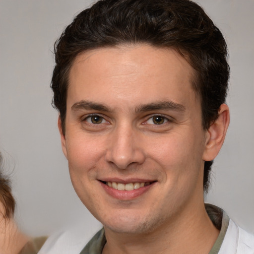 Joyful white young-adult male with medium  brown hair and brown eyes