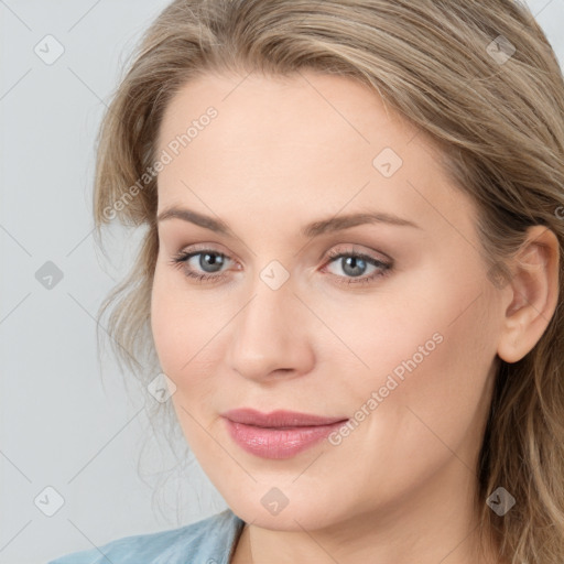 Joyful white young-adult female with medium  brown hair and blue eyes