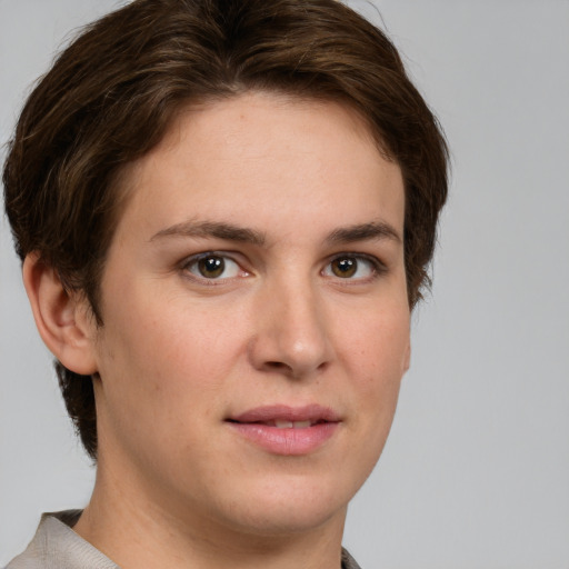 Joyful white young-adult female with short  brown hair and grey eyes