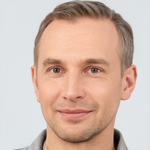 Joyful white adult male with short  brown hair and brown eyes