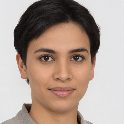 Joyful latino young-adult female with short  brown hair and brown eyes