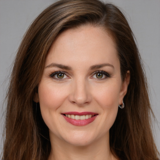 Joyful white young-adult female with long  brown hair and green eyes