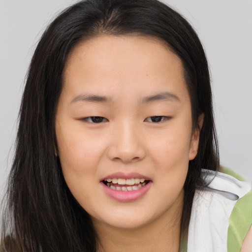 Joyful asian young-adult female with long  brown hair and brown eyes