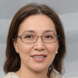 Joyful white adult female with medium  brown hair and brown eyes