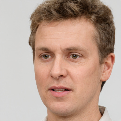 Joyful white adult male with short  brown hair and grey eyes