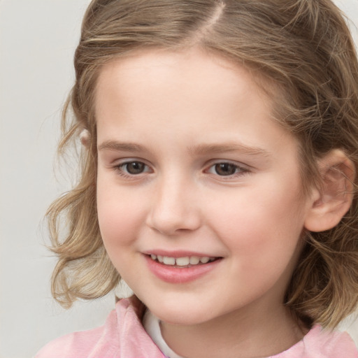 Joyful white child female with medium  brown hair and brown eyes