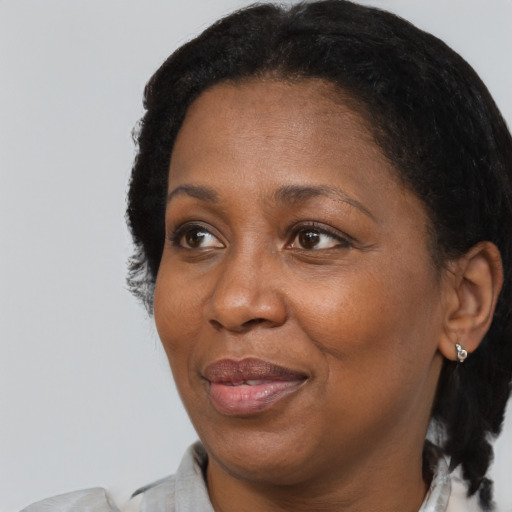 Joyful black adult female with short  brown hair and brown eyes