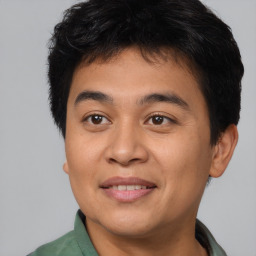 Joyful asian young-adult male with short  brown hair and brown eyes