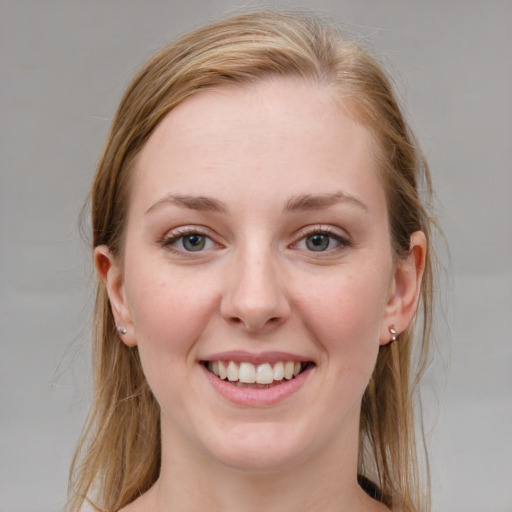 Joyful white young-adult female with medium  brown hair and blue eyes