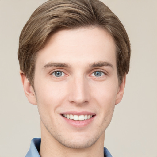 Joyful white young-adult male with short  brown hair and grey eyes