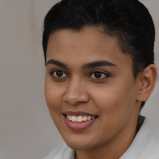 Joyful latino young-adult female with short  brown hair and brown eyes