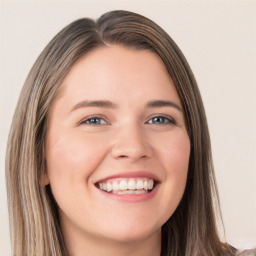 Joyful white young-adult female with long  brown hair and blue eyes