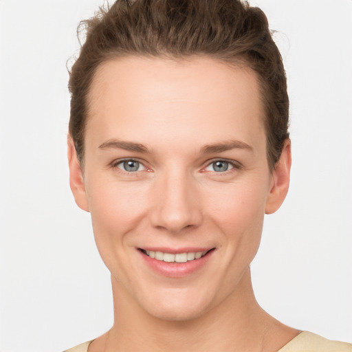 Joyful white young-adult female with short  brown hair and grey eyes