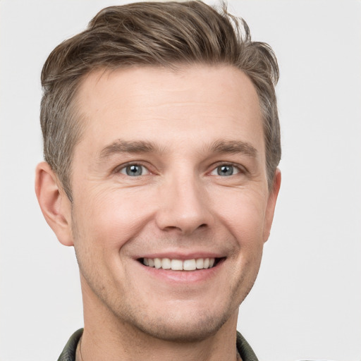 Joyful white young-adult male with short  brown hair and grey eyes