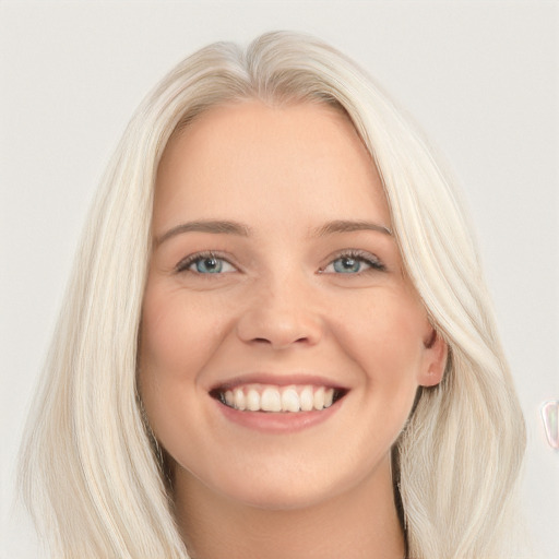 Joyful white young-adult female with long  blond hair and blue eyes