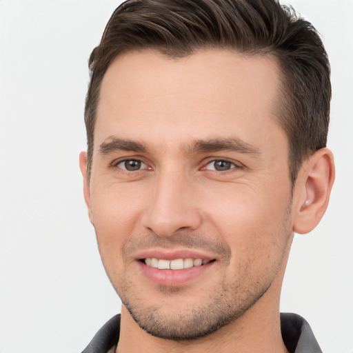 Joyful white young-adult male with short  brown hair and brown eyes