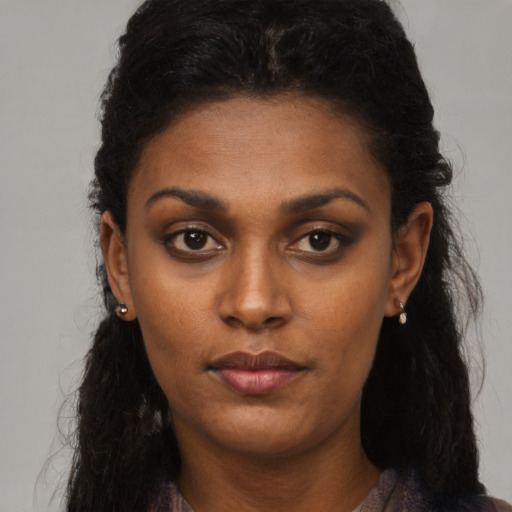 Neutral black young-adult female with long  brown hair and brown eyes
