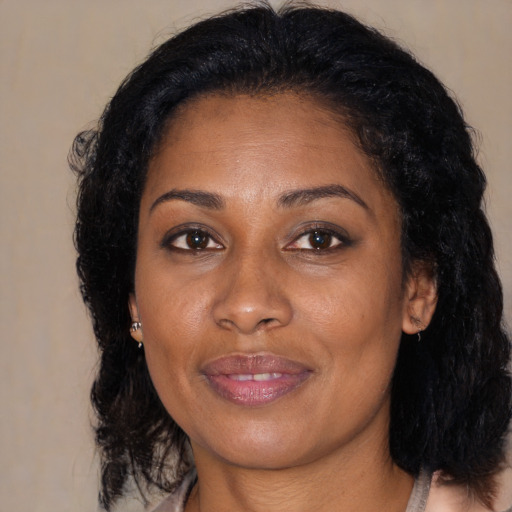 Joyful black young-adult female with medium  brown hair and brown eyes