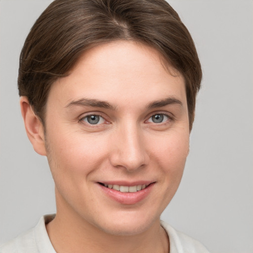 Joyful white young-adult female with short  brown hair and grey eyes