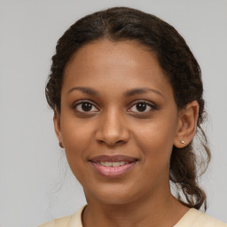 Joyful black young-adult female with medium  brown hair and brown eyes