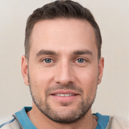 Joyful white young-adult male with short  brown hair and grey eyes