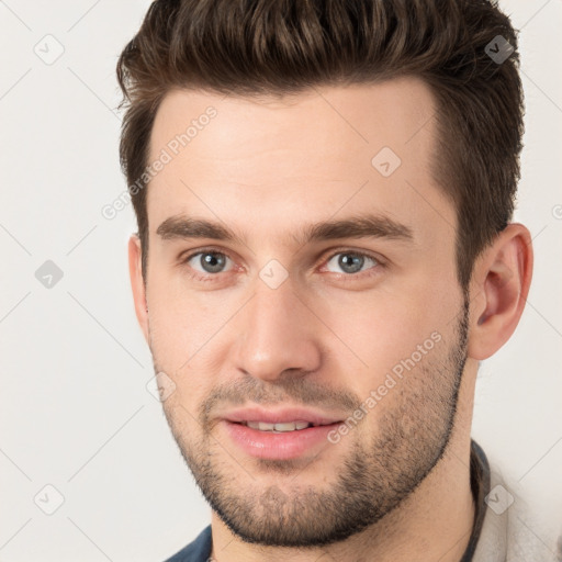 Joyful white young-adult male with short  brown hair and brown eyes