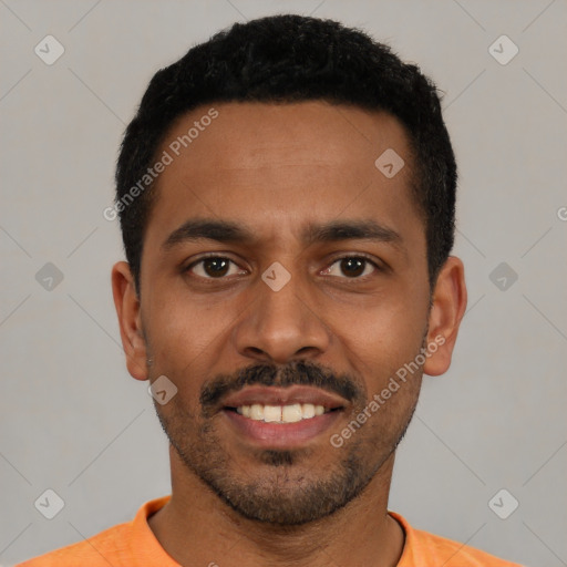 Joyful black young-adult male with short  black hair and brown eyes
