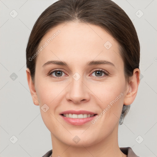 Joyful white young-adult female with short  brown hair and grey eyes