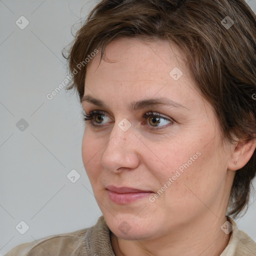 Joyful white adult female with medium  brown hair and brown eyes