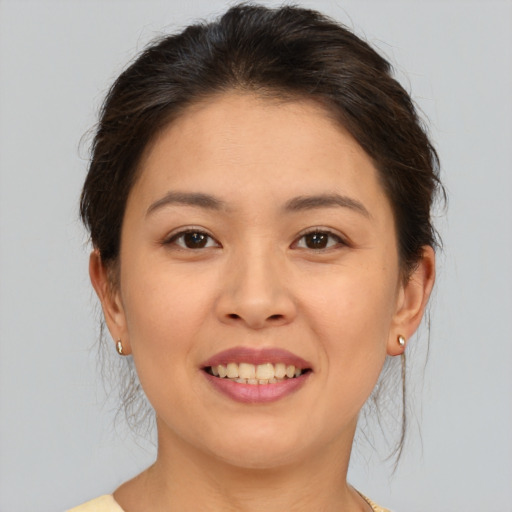 Joyful white young-adult female with medium  brown hair and brown eyes