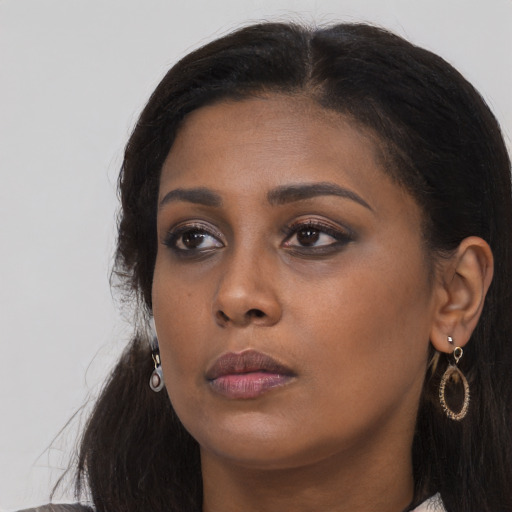 Neutral black young-adult female with long  brown hair and brown eyes