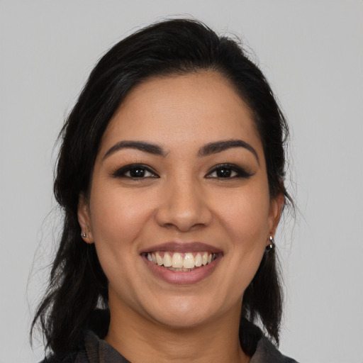 Joyful latino young-adult female with long  black hair and brown eyes