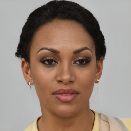 Joyful latino young-adult female with short  brown hair and brown eyes