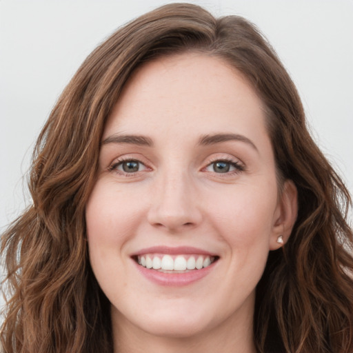 Joyful white young-adult female with long  brown hair and green eyes