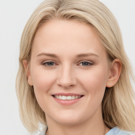 Joyful white young-adult female with long  brown hair and blue eyes