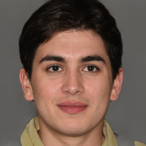 Joyful latino young-adult male with short  brown hair and brown eyes