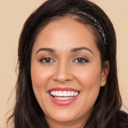 Joyful white young-adult female with long  black hair and brown eyes