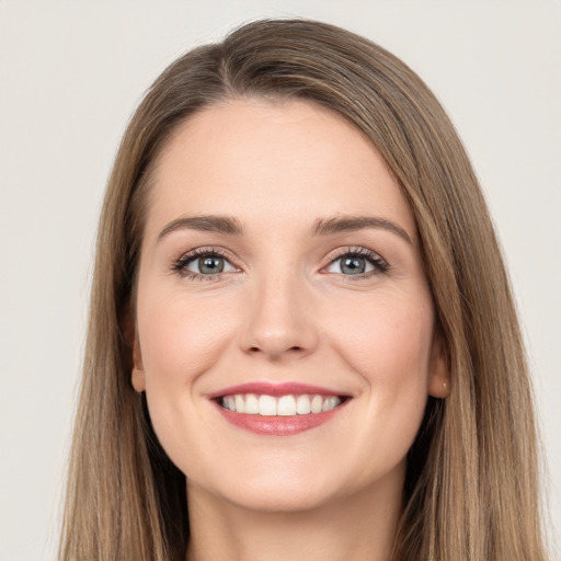 Joyful white young-adult female with long  brown hair and grey eyes