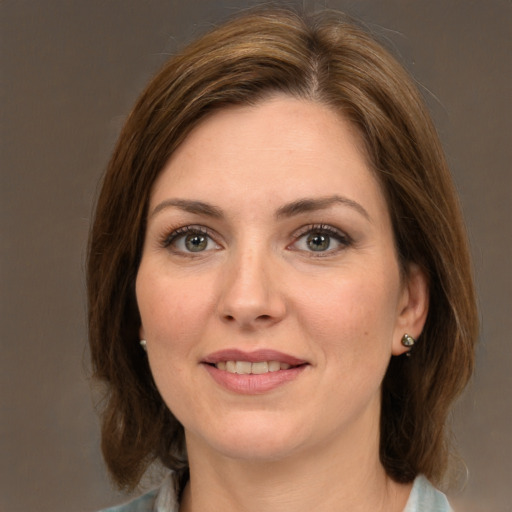 Joyful white adult female with medium  brown hair and green eyes