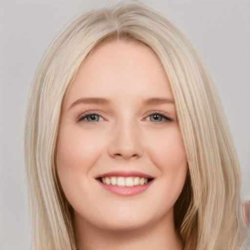 Joyful white young-adult female with long  blond hair and brown eyes