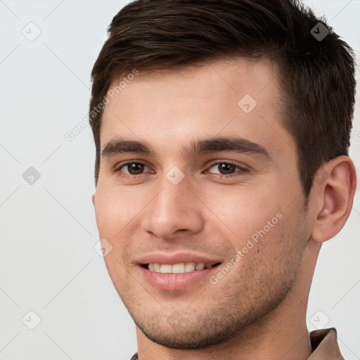 Joyful white young-adult male with short  brown hair and brown eyes