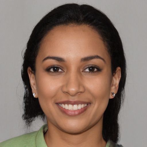 Joyful latino young-adult female with long  black hair and brown eyes
