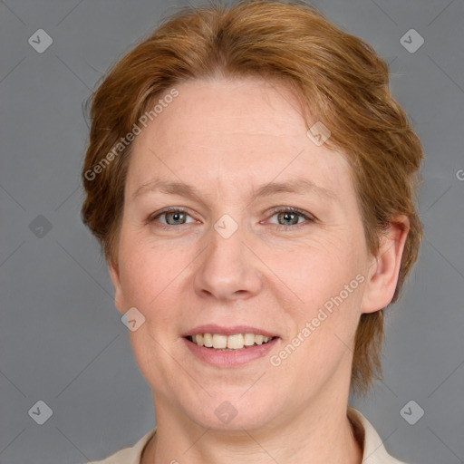 Joyful white adult female with medium  brown hair and blue eyes