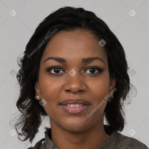 Joyful black young-adult female with long  black hair and brown eyes