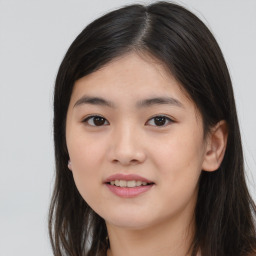 Joyful asian young-adult female with long  brown hair and brown eyes