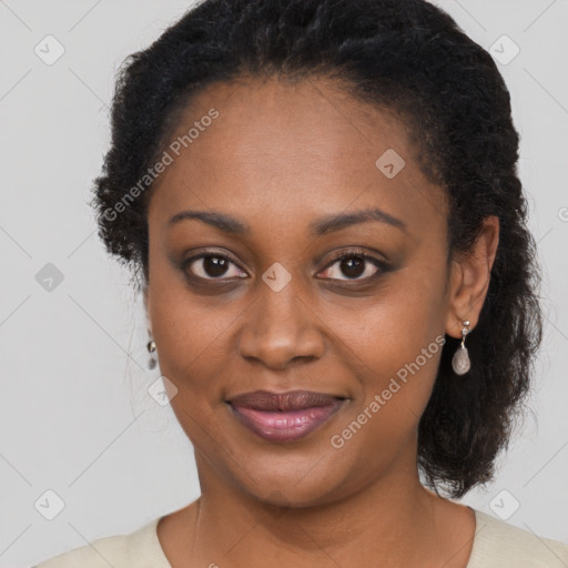 Joyful black young-adult female with long  brown hair and brown eyes