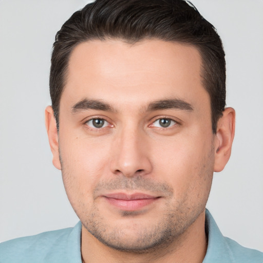 Joyful white young-adult male with short  brown hair and brown eyes