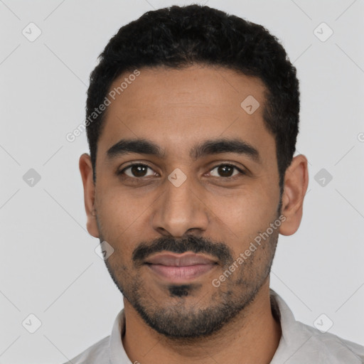 Joyful latino young-adult male with short  black hair and brown eyes