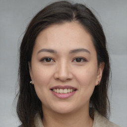 Joyful asian young-adult female with medium  brown hair and brown eyes